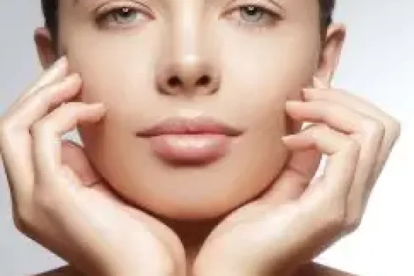 Ritratto di una donna con mani appoggiate al viso.